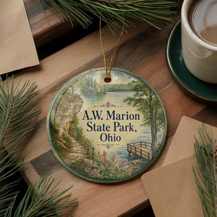 A decorative ornament with a scenic landscape of A.W. Marion State Park, Ohio, featuring a river, bridge, and pine trees.