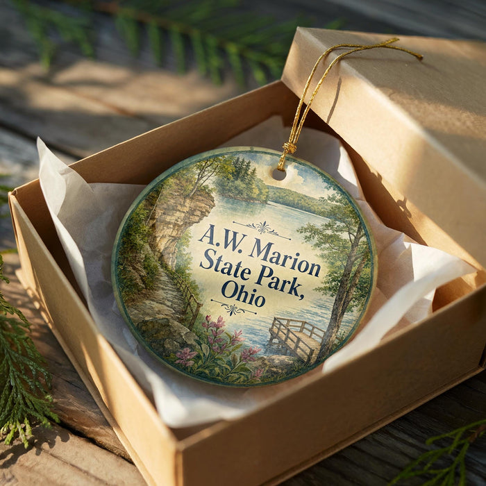 A decorative ornament in a wooden box, featuring a scenic landscape with a river, trees, and a bridge.