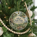 A Christmas tree decorated with ornaments, including a circular ornament with a scenic image of Aiken State Park, South Carolina.