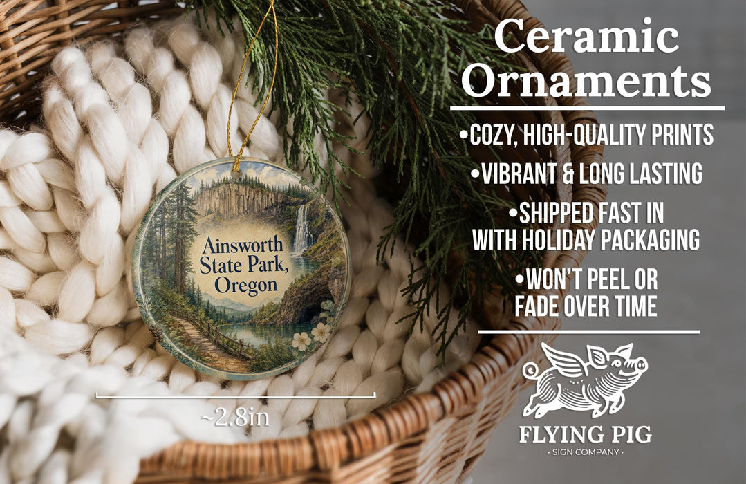 Ceramic ornaments, featuring a scenic landscape of Ainsworth State Park, Oregon, hanging from a wicker basket.