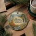 A round ornament with a scenic landscape of Allegany State Park, New York, featuring a waterfall, pine trees, and a deer.