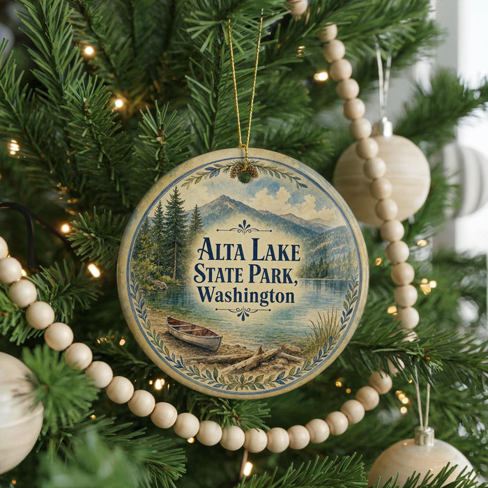A round ornament hanging on a Christmas tree, featuring a scenic image of Alta Lake State Park in Washington.