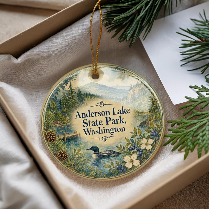 A decorative ornament with a lake scene and pine trees, featuring the text "Anderson Lake State Park, Washington".