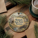 A decorative ornament featuring a scenic image of Banack State Park, Montana, with a small cabin and a stream in the foreground.