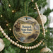 A round ornament hanging on a Christmas tree, featuring a scenic image of Banack State Park, Montana.