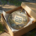 A decorative ornament in a wooden box, featuring a scenic image of Bannack State Park, Montana.