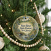 A round ornament hanging on a Christmas tree, featuring a scenic image of the Bass River State Forest in New Jersey.