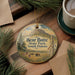 A round ornament with a scenic landscape of Bear Butte State Park, South Dakota, featuring a mountain, pine trees, and wildlife.