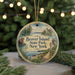 A round ornament with a painting of Beaver Island State Park, New York, featuring a bear and a lighthouse, is displayed on a Christmas tree.