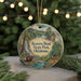 A circular ornament featuring a scenic landscape with a waterfall, bears, and deer, hanging from a string.
