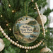 A round ornament hanging on a Christmas tree, featuring a scenic image of Belfair State Park in Washington.