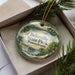 A decorative ornament in a box, featuring a scenic landscape with a waterfall and trees, with the text "Beltzville State Park, Pennsylvania" prominently displayed.