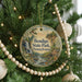 A round ornament hanging on a Christmas tree, featuring a scenic image of Bendigo State Park in Pennsylvania.