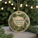 A round ornament with a scenic landscape of Benjamin Rush State Park, Pennsylvania, featuring a waterfall, a cabin, and a forest.
