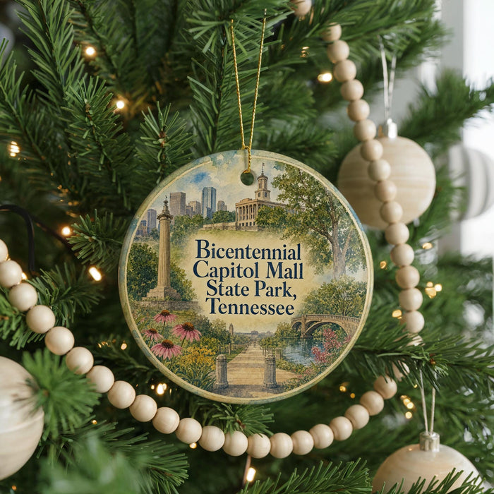 A circular ornament hanging on a Christmas tree, featuring an illustration of Capitol Mall in Tennessee.