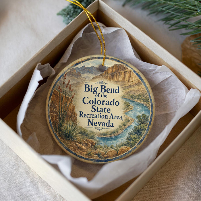 A decorative ornament in a box, featuring a scenic image of the Big Bend of the Colorado State Recreation Area, Nevada.