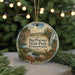 A decorative ornament featuring a scenic landscape with a waterfall, pine trees, and a deer, hanging from a string.