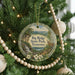 A Christmas tree decorated with ornaments, including a circular ornament with a scenic image of Big Ridge State Park, Tennessee.