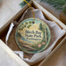 A round ornament with a scenic image of Birch Bay State Park in Washington, featuring a lake, trees, and flowers.