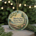 A round ornament with a scenic image of Birch Bay State Park, Washington, hanging from a string.