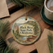 A decorative ornament featuring a scenic image of Black Mesa State Park, Oklahoma, with pine branches and a cup of coffee nearby.