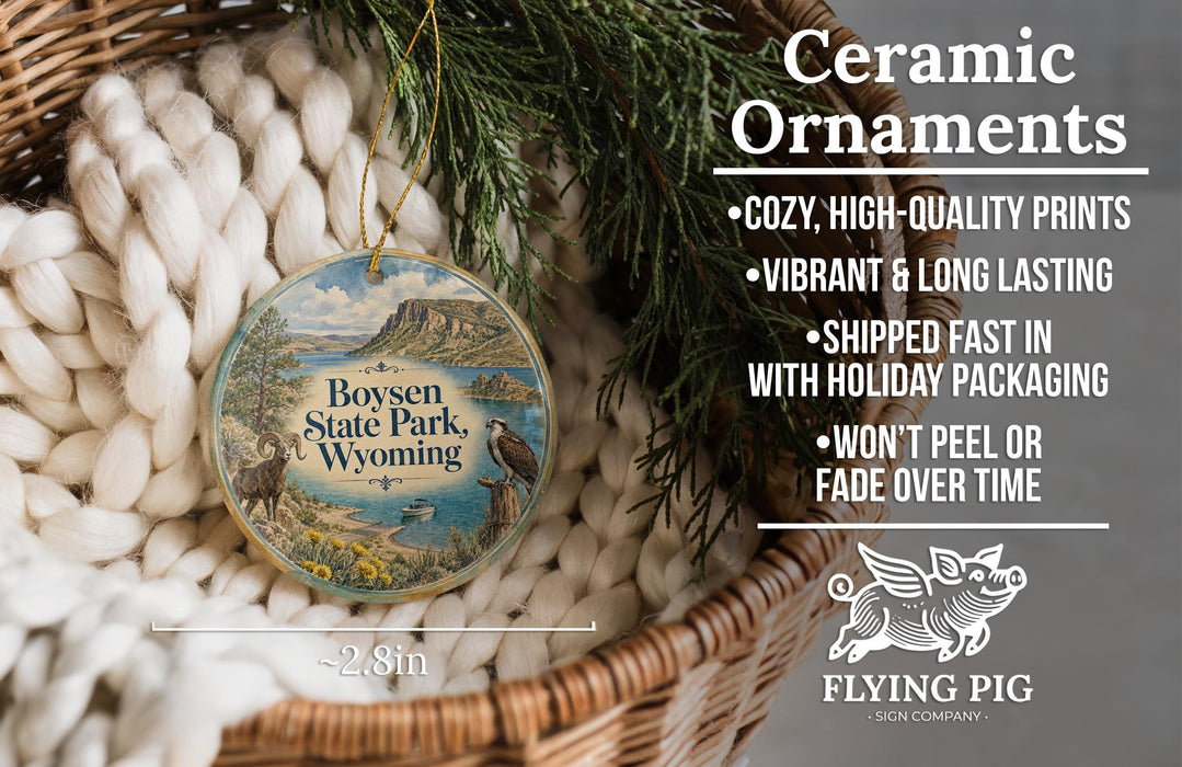 Ceramic ornaments, featuring a round ornament with a landscape design and text, placed in a woven basket.