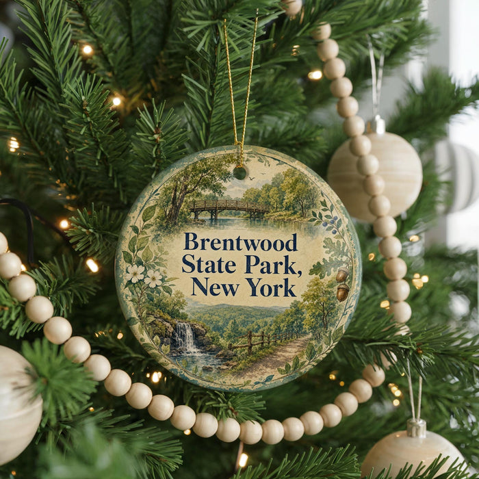A round ornament hanging on a Christmas tree, featuring a scenic image of Brentwood State Park in New York.