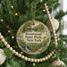 A round ornament hanging on a Christmas tree, featuring a scenic image of Brentwood State Park in New York.