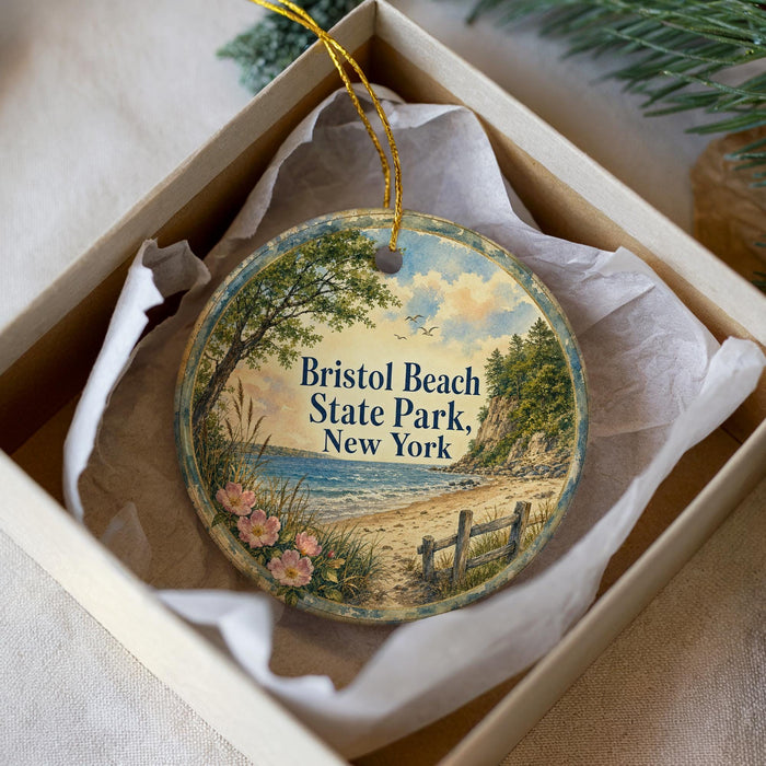 A round ornament in a box, featuring a scenic image of Bristol Beach State Park in New York.