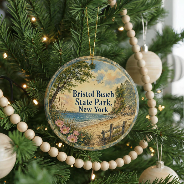 A round ornament hanging on a Christmas tree, featuring a scenic image of Bristol Beach State Park in New York.