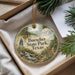 A decorative ornament with a scenic landscape of Buescher State Park, Texas, featuring a deer, pine trees, and a waterfall.