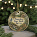 A circular ornament with a scenic illustration of a park, featuring a house, trees, and a deer, is displayed in front of a blurred background with Christmas lights.