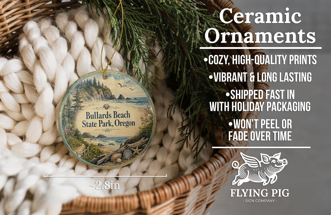 Ceramic ornaments, specifically a round ornament with a scenic image of Bullards Beach State Park, Oregon, hanging from a wicker basket.
