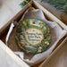 A decorative ornament in a box, featuring a scenic image ofBURGEOUS FALLS STATE PARK, TENNESSEE.