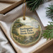 A round ornament with a scenic landscape of burlingame state park, Rhode island, hanging from a string.