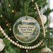 A round ornament hanging on a Christmas tree, featuring a scenic image of Burton Island State Park, Vermont.