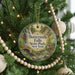 A round ornament hanging on a Christmas tree, featuring a scenic image of Butermilk Falls State Park in New York.