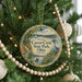 A round ornament hanging on a Christmas tree, featuring a scenic image of Caesar Creek State Park, Ohio.
