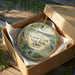 An ornament in a brown box, featuring a scenic image of Caesar Creek State Park in Ohio.