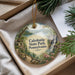A decorative ornament with a scenic landscape of Caledonia State Park, Pennsylvania, featuring a waterfall, pine trees, and a path.