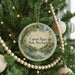 A round ornament on a Christmas tree, featuring a scenic landscape with a river and a bridge, with the text "Calvert Vaux Park, New York" displayed on it.