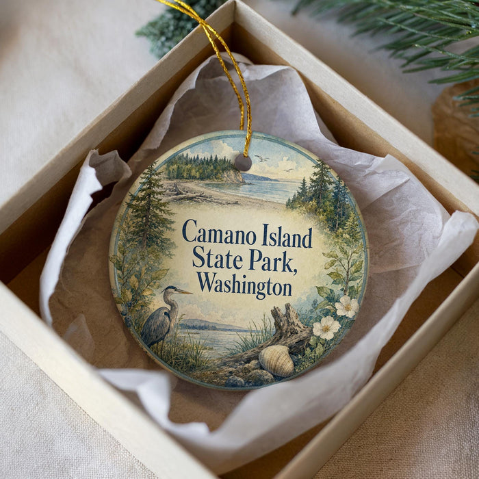 A decorative ornament in a white box, featuring a serene landscape with a bird and trees, along with the text "Camao Island State Park, Washington".