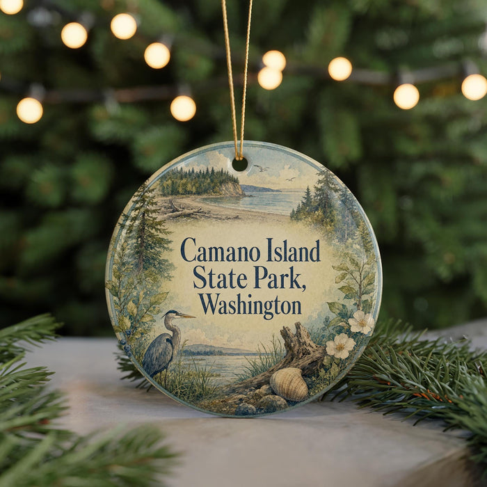 A round ornament with a scenic image of Camano Island State Park, Washington, featuring a heron, a tree, and a body of water.