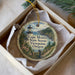 A decorative ornament in a box, featuring a lighthouse and a scenic view of Cape Meare's State Scenic Viewpoint in Oregon.