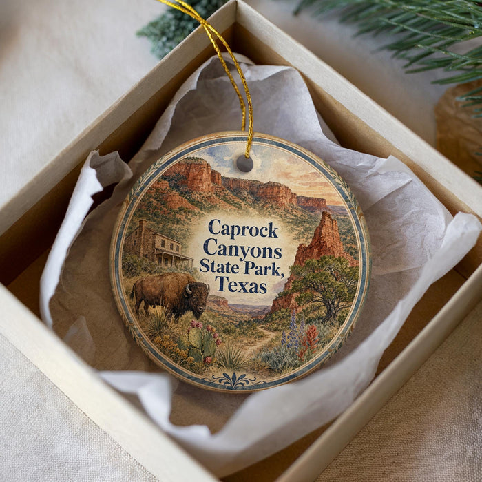 A decorative ornament in a box, featuring a scenic image of Caprock Canyon State Park, Texas.