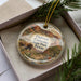 A decorative ornament featuring a scenic image of Caprock Canyon State Park, Texas, with a bison and desert landscape.