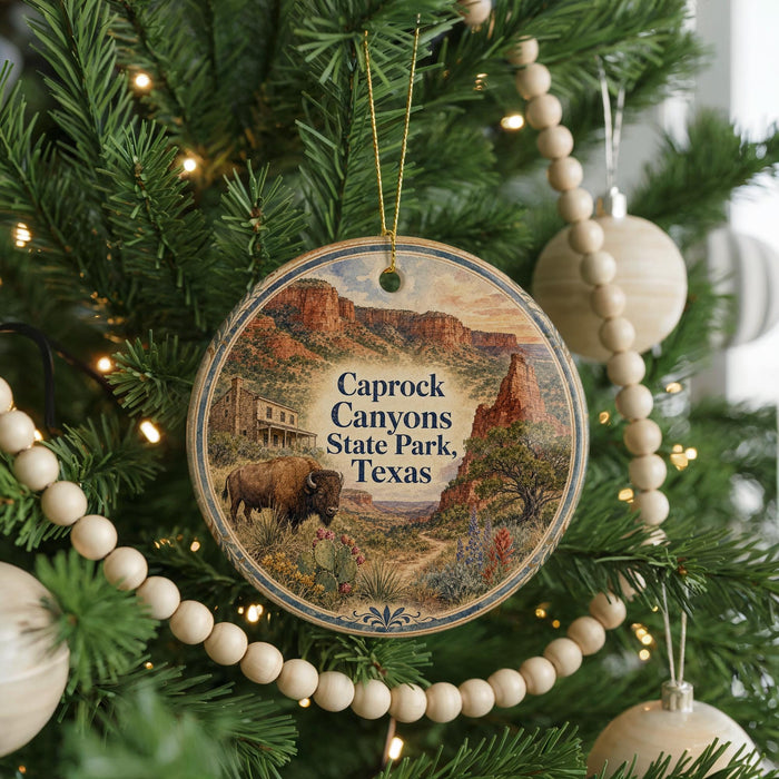 A circular ornament hanging on a Christmas tree, featuring a scenic image of Caprock Canyon State Park, Texas.