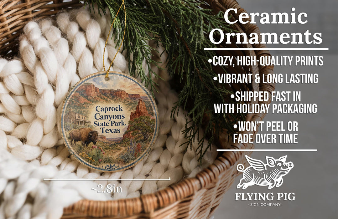 Ceramic ornaments, featuring a picture of a state park in Texas, are displayed in a basket with greenery.