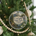 A Christmas tree decorated with ornaments, including a circular ornament with a scenic image of the Cascade State Park in Oregon.