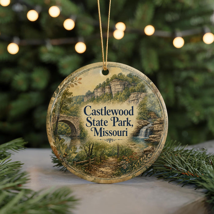 A round ornament with a scenic landscape of Castlewood State Park, Missouri, featuring a bridge, waterfall, and greenery.
